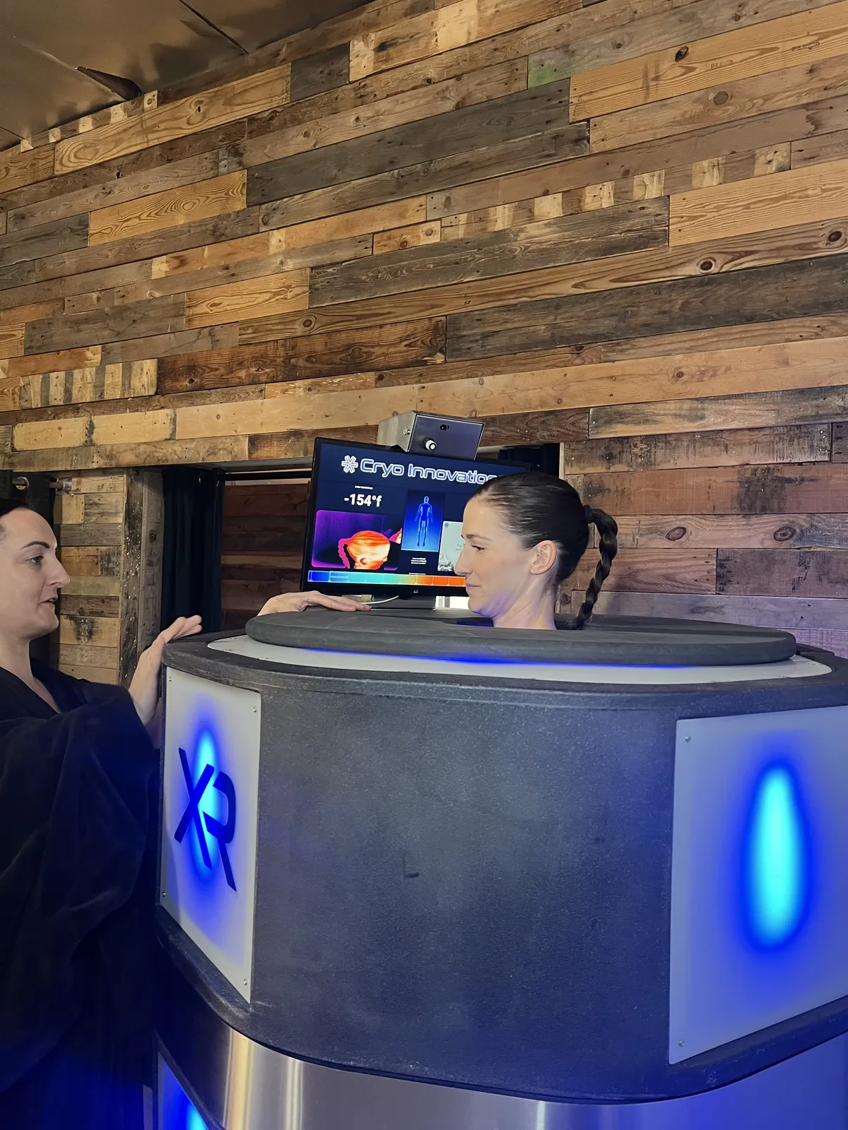Staff member operating the chamber touchscreen before a session