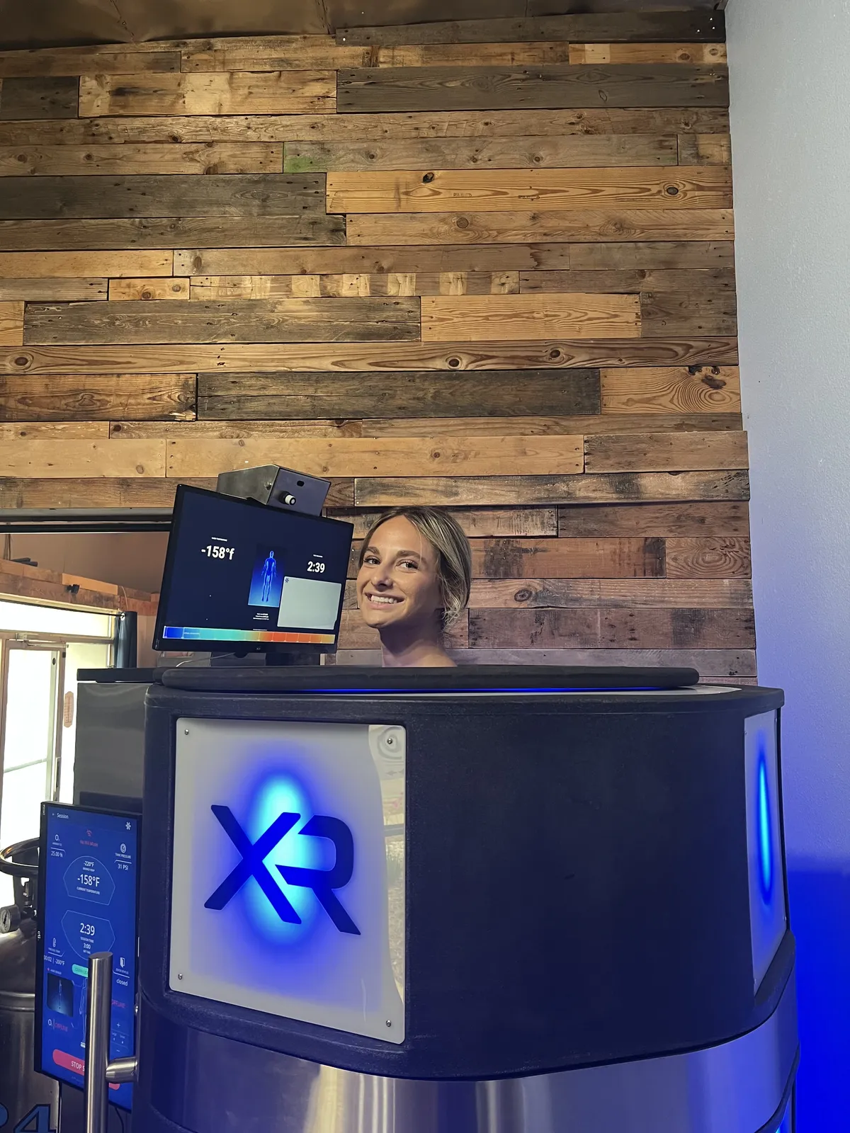 Client mid-session in the XR chamber, cabin display visible