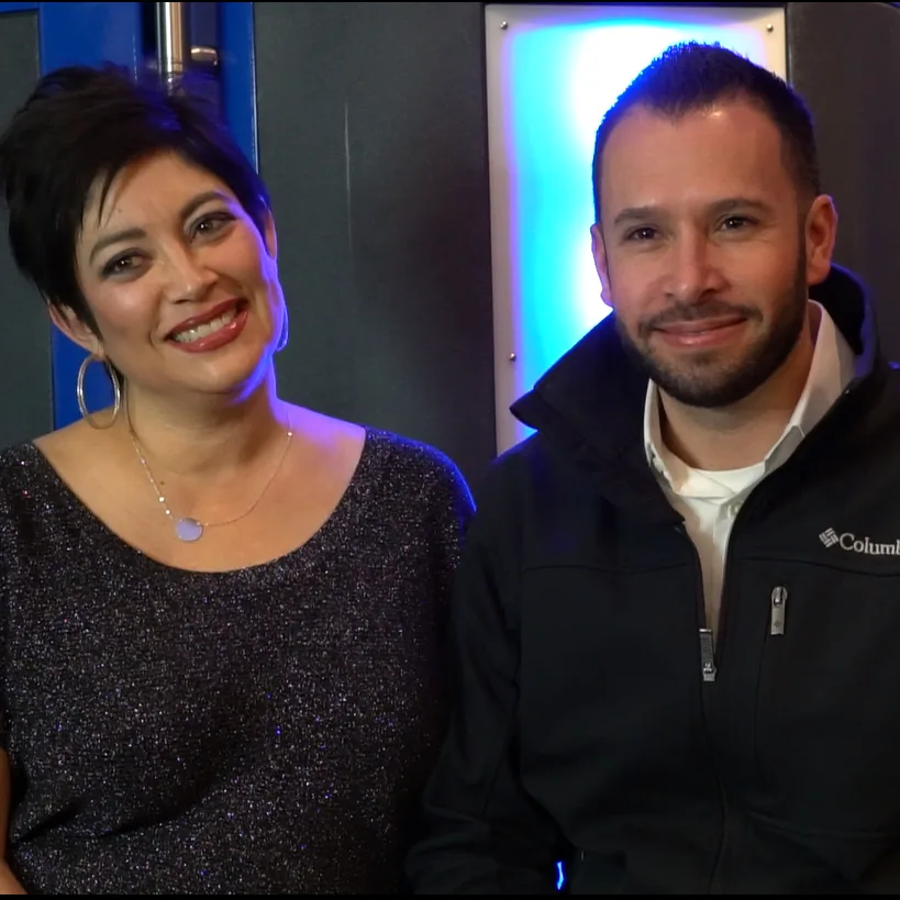 Adam and Julie Aragon, founders of Studio 127 Salon and Day Spa, in front of their XR chamber