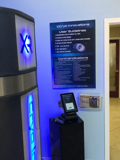 Instructional poster boards mounted on the wall beside an XR chamber
